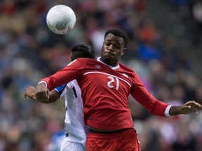 Canada's Cyle Larin and Honduras' Luis Garrido vie for the ball during second half CONCACAF World Cup qualifying soccer action at BC Place in Vancouver on Nov. 13, 2015. (THE CANADIAN PRESS/Darryl Dyck)