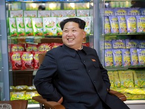 North Korean leader Kim Jong Un smiles while sitting during a visit to inspect the Pyongyang Children's Foodstuff Factory, in this undated photo released by North Korea's Korean Central News Agency (KCNA) on November 14, 2015.    REUTERS/KCNA