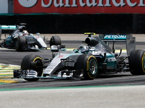 Mercedes driver Nico Rosberg, of Germany, leads followed by teammate Lewis Hamilton, of Britain,  during the Formula One Brazilian Grand Prix in Sao Paulo, Brazil. Rosberg went on to win. (ANDRE PENNER/AP)