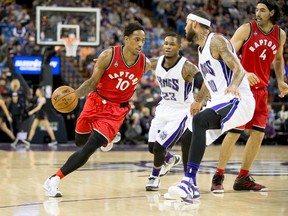 Toronto Raptors guard DeMar DeRozan (10) dribbles the ball against Sacramento Kings guard Ben McLemore (23) and centre Willie Cauley-Stein (00) on Nov. 15. (Kelley L Cox-USA TODAY Sports)