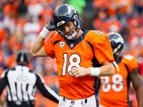 Denver Broncos quarterback Peyton Manning (18) takes off his helmet after throwing an interception against the Kansas City Chiefs, Sunday, Nov. 15, 2015, in Denver. (AP Photo/Jack Dempsey)