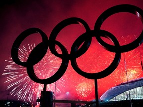 The Olympic rings are silhouetted as fireworks light up the sky during the closing ceremony at the 2014 Sochi Winter Olympics in Sochi, Russia on Sunday, February 23, 2014. (THE CANADIAN PRESS/Nathan Denette)