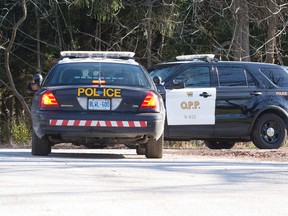 OPP cruisers are seen at the end of Brayside Street home in Port Stanley. Police were investigating a Saturday evening fire on the dead-end road. Craig Glover/The London Free Press/Postmedia Network