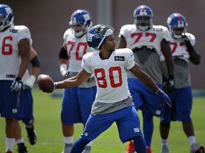 In this Aug. 2, 2015 file photo, New York Giants receiver Victor Cruz throws the ball during a training camp practice in East Rutherford, N.J. (AP Photo/Seth Wenig)