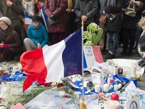 People attend a rally of solidarity outside the Consulate of France, in Montreal, on Nov. 15, 2015, to show their support to the victims of the Paris attacks. (THE CANADIAN PRESS/Graham Hughes)