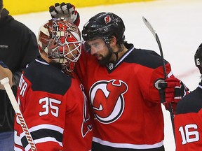 New Jersey Devils defenceman David Schlemko (right) congratulates goalie Cory Schneider on his shutout win over the Pittsburgh Penguins at Prudential Center. (Ed Mulholland/USA TODAY Sports)