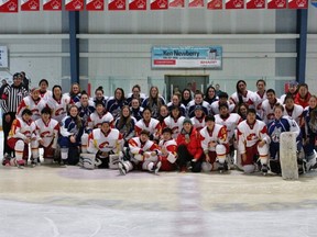 The Sudbury Lady Wolves AA midget hockey team poses for a photo with the Chinese national women's team following their game Saturday. The Lady Wolves won 4-0.