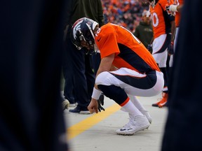 Quarterback Peyton Manning of the Denver Broncos crouches on the sidelines during a game against the Kansas City Chiefs at Sports Authority Field Field in Denver on Nov. 15, 2015. (Justin Edmonds/Getty Images/AFP)