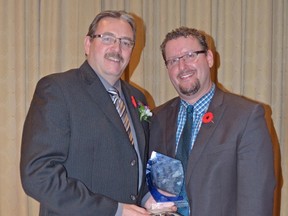 Ed Berney (left) of North Central Co-op receives the Business of the Year Award on behalf of North Central Co-op, presented by Devin Selte of Servus Credit Union. - Thomas Miller, Reporter/Examiner