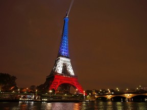 The Eiffel Tower is lit with the blue, white and red colours of the French flag in Paris, France, November 16, 2015, to pay tribute to the victims of a series of deadly attacks on Friday in the French capital.  REUTERS/Benoit Tessier