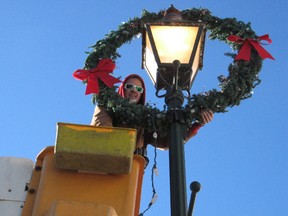 It's that time of year again. Dallas Carter, with electrical contractor M.A. Electric, was high in the air installing decorative wreaths on lamp posts on a sunsplashed day, on Montreal Road in Cornwall's east end, on Monday November 16, 2015 in Cornwall, Ont. Todd Hambleton/Cornwall Standard-Freeholder/Postmedia Network