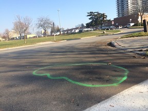 Green spray paint at the corner of Golden Orchard Dr. and Grand Forks Rd., in Mississauga, marks the spot where a man, 26, was shot by Peel Regional Police early Saturday. (CHRIS DOUCETTE, Toronto Sun)