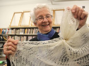 Sylvia Currie, a member of the Kingston Handloom Weavers and Spinners, shows the wedding band shawl she made, so-called because it is so delicate it can pass through a wedding ring, at the club's new room in the Tett Centre in Kingston. The group will be holding its fall sale later this month. (Michael Lea/The Whig-Standard)