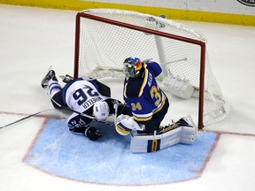Winnipeg Jets' Blake Wheeler, left, slides into the net past St. Louis Blues goalie Jake Allen during the second period of an NHL hockey game Monday, Nov. 16, 2015, in St. Louis. (AP Photo/Jeff Roberson)
