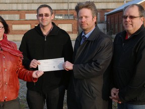 Elgin County Railway Museum manager Dawn Miskelly, left, Jeremy Locke, board president, Andrew Gunn, estate trustee, and Paul Corriveau, president of the Iron Horse Festival show off the $20,000 donation made by the Dorothy Palmer estate Friday. The money will be used to fund a conceptual site plan for the property adjacent to the museum. (Jennifer Bieman/Times-Journal)