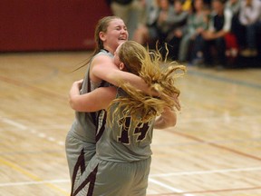 Sisters Brett and Sawyer Fischer embrace after the Wallaceburg Tartans beat the St. Clair Colts 42-40 on Saturday in Wallaceburg to win the LKSSAA 'AA' senior girls basketball title.
