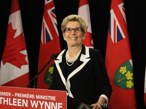 Premier Kathleen Wynne tells media on Tuesday that her government intends to honour its pledge to bring in 10,000 Syrian refugees by the end of 2016. (Antonella Artuso/Toronto Sun)