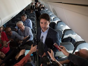 Prime Minister Justin Trudeau speaks to reporters while flying from Antalya, Turkey to Manila, Philippines on  Tuesday, Nov. 17, 2015, to attend the APEC Summit. THE CANADIAN PRESS/Sean Kilpatrick