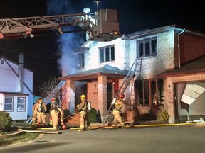 Ottawa firefighters battle a house blaze on Normandy Cres., on Monday, Nov. 16, 2015. It has been deemed suspicious by the arson squad. (COREY LAROCQUE Ottawa Sun/Postmedia Network)