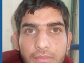 This undated photo released late Sunday, Nov. 15, 2015, by Greece's migration policy ministry shows a registration photo from a document issued to 25-year old Ahmad Almohammad, holder of a Syrian passport found near a dead assailant in the scene of a Paris attack Friday. (Greek Migration Ministry via AP)