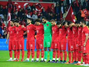 Turkey’s players observe a minute of silence to honour the victims of the Paris attacks prior to an international friendly against Greece in Istanbul Tuesday Nov. 17, 2015. (AP Photo/Lefteris Pitarakis)