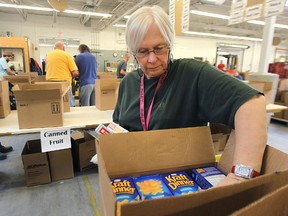 Food ban usage in Manitoba was up in March 2015, according to a new report. In this file photo, Joey-Jayne Hyltun volunteers at Winnipeg Harvest. (Kevin King/Winnipeg Sun file photo)