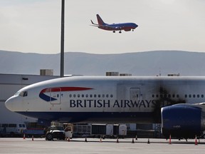 A damaged British Airways Boeing 777-200 sits at McCarran International Airport Wednesday, Sept. 9, 2015, in Las Vegas. An engine caught fire before takeoff Tuesday forcing the evacuation of the crew and passengers. (AP Photo/John Locher)