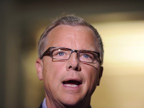Saskatchewan Premier Brad Wall speaks at the Saskatchewan Legislative Building in Regina, Sask., Friday, July 24, 2015. Wall wants the federal government to suspend its plan to bring in 25,000 Syrian refugees by the end of the year. THE CANADIAN PRESS/Mark Taylor