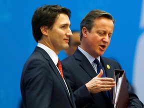 Canada's Prime Minister Justin Trudeau (L) and British Prime Minister David Cameron attend a working session at the Group of 20 (G20) summit in the Mediterranean resort city of Antalya, Turkey, November 15, 2015. Trudeau has confirmed Canada will send an enlarged force of infantry trainers to fight ISIS. REUTERS/Murad Sezer