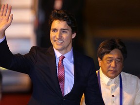 Canadian Prime Minister Justin Trudeau waves on his arrival for the Asia-Pacific Economic Cooperation (APEC) summit in Manila, Philippines, Tuesday, Nov. 17, 2015. Leaders from 21 countries and self-governing territories are gathering in Manila for the Asia-Pacific Economic Cooperation summit. The meeting's official agenda is focused on trade, business and economic issues but terrorism, South China Sea disputes and climate change are also set to be in focus.(AP Photo/Aaron Favila)