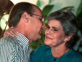 In this Sept. 7, 1995, file photo, Chief of Staff Antonio Lacayo kisses Nicaraguan President Violeta Chamorro, his mother-in-law, after receiving a certificate for good service to the republic during his tenure. Lacayo went missing on Nov. 17, 2015, after the helicopter he was travelling in went down in the southern zone of the country. According to police, two bodies have been recovered of the four persons aboard. Lacayo's body was found on Nov. 18. (AP Photo/Anita Baca, File)