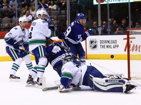 Joffrey Lupul of the Toronto Maple Leafs scores on Ryan Miller of the Vancouver Canucks during NHL action at the Air Canada Centre in Toronto on Nov. 14, 2015. (Dave Abel/Toronto Sun/Postmedia Network)