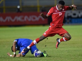 El Salvador's Henry Romero and Canada's Tosaint Ricketts vie for the ball during their Russia 2018 FIFA World Cup CONCACAF Qualifiers football match, in San Salvador, on Nov. 17, 2015. (AFP PHOTO/MARVIN RECINOS)