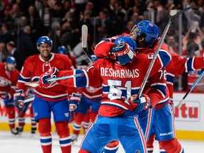 David Desharnais of the Montreal Canadiens celebrates his overtime goal with teammates during the NHL game against the Vancouver Canucks at the Bell Centre in Montreal on Nov. 16, 2015. (Minas Panagiotakis/Getty Images/AFP)