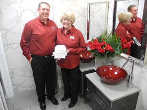 Wayne Lowrie/Postmedia Network
Jeff Butler and Heather Howard proudly display their award in the women's restroom of their Thousand Islands Duty Free Shop.