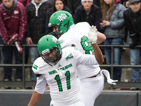 North Dakota wide receiver Luke Stanley, right, celebrates with wide receiver Miguel Cerriteno (11) after scoring a touchdown in the second half of an NCAA college football game last month. On Wednesday, UND announced its new nickname: The Fighting Hawks. (AP file Photo/Patrick Record)