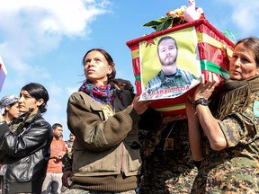 Kurdish People's Protection Units (YPG) fighters carry the coffin of fellow fighter John Robert Gallagher, a Canadian who died on Nov. 4 in battle with Islamic State fighters, during his funeral in Hasaka, Syria Nov. 12, 2015. REUTERS/Rodi Said