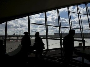 People are seen in silhouette inside the Trans World Airlines Flight Center at John F. Kennedy Airport in the Queens borough of New York, October 18, 2015. REUTERS/Shannon Stapleton