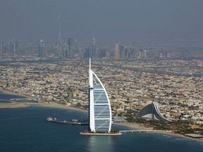 This Sunday, Jan. 3, 2010 file photo, shows an Ariel view of Burj Al Arab, the luxury hotel, center, in Dubai, United Arab Emirates. If you don't have an extra $15,000 or so to spend on a night in a royal suite at Dubai's luxury Burj Al Arab hotel, there's now an online tour that offers a free virtual glimpse of its extravagance. (AP Photo/Kamran Jebreili, File)