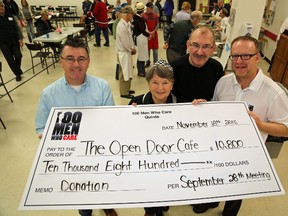 100 Men Who Care Quinte club members, Tony McGarvey (first Left) and Ian Press (first right) make a donation of $10,800 to Frank Hamper and Brenda Miller , volunteers with local meal program oThe Open Door Cafe. Jason Miller/The Intelligencer