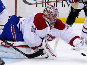 Montreal Canadiens goalie Carey Price (31) covers a loose puck during NHL action against the Pittsburgh Penguins in Pittsburgh Tuesday, Oct. 13, 2015. (AP Photo/Gene J. Puskar)