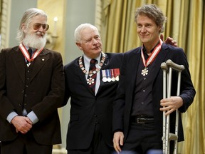 Governor General David Johnston (C) poses with musicians Jim Cuddy (R) and his Blue Rodeo bandmate Greg Keelor after they were awarded the rank of Officer in the Order of Canada during a ceremony at Rideau Hall in Ottawa, Canada November 18, 2015. REUTERS/Chris Wattie