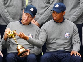 U.S. captain Davis Love III (left) looks at the Ryder Cup with Tiger Woods at the Medinah Country Club in Medinah, Illinois, September 25, 2012. (REUTERS/Jeff Haynes)