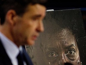 A domestic violence poster is visible behind EPS Domestic Offender Crimes Section Staff Sgt. Sean Armstrong, as he speaks to the media about domestic violence during a press conference at police headquarters, in Edmonton Alta., on Tuesday Jan. 6, 2015. David Bloom/Edmonton Sun