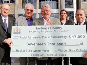 Luke Hendry/The Intelligencer
Habitat for Humanity's local executive director, Bob Clute, centre, accepts a cheque from Hastings County officials at the county office in Belleville Wednesday. With him from left are Warden Rick Phillips, Quinte West Mayor Jim Harrison, Habitat's Bojanna Lough and county social services committee chairman Garnet Thompson.