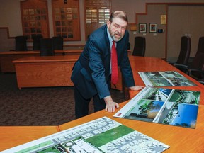 David Jackson, the Limestone District School Board chair, looks over the concept designs for the boards new intermediate and secondary school at the board office in Kingston, Ont. on Wednesday November 18, 2015. The site for the new school has created a lot of public debate as it will be the new home for student from both Kingston Collegiate and Queen Elizabeth Collegiate. Julia McKay/The Kingston Whig-Standard/Postmedia Network