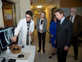 Jeff Gaudet, a medical biophysics PHD student, explains magnetic resonance imaging to Martin Short during his tour of Robarts Research Institute at Western University in London, Ont. on Wednesday November 18, 2015. The world famous  Canadian actor was the keynote speaker for the Leaders in Innovation Dinner which celebrated research excellence in the field of cellular and molecular imaging in the field of cancer. (DEREK RUTAN, The London Free Press)