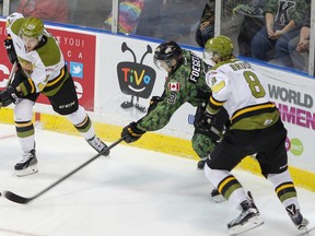 Kingston Frontenacs' Warren Foegele reaches for the puck in the North Bay Battalion end against Brett McKenzie and Riley Bruce during the first period of Ontario Hockey League action at the Rogers K-Rock Centre on Nov. 6. It was Foegele's first home game with the Frontenacs after being signed by the team a week earlier. (Julia McKay/The Whig-Standard)