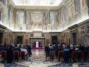 Pope Francis meets members of the Jesuit Refugee Service group, in the Clementine Hall at the Vatican, Saturday, Nov. 14, 2015. Pope Francis says he is "saddened" by the terror attacks in Paris and that there is "no justification" for such actions. The pope, with a heavy and measured voice, made the comments in a phone call broadcast on the Italian Bishop's Conference TG2000. (L'Osservatore Romano/Pool Photo via AP)