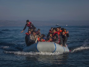 Refugees and migrants arrive safely on a dinghy from the Turkish coast to the northeastern Greek island of Lesbos. (AP Photo/Santi Palacios)